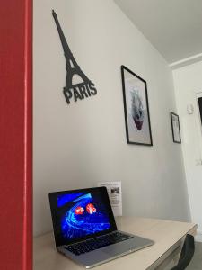 a laptop computer sitting on top of a desk at Hotel centre Rouen in Rouen