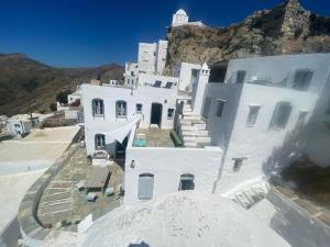 an aerial view of a white building with a tower at Windhouses Serifos in Serifos Chora