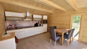 a kitchen with a table and chairs in a room at Torhaus Terra Nova in Elsterheide