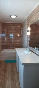 a bathroom with a white sink and a tub at Swan Bay complex in Chernomorets +36 photos