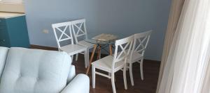 a living room with a table and chairs and a couch at Swan Bay complex in Chernomorets