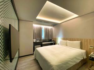 Postelja oz. postelje v sobi nastanitve Hub Hotel Ximen Inn