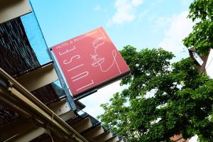 a red street sign with graffiti on it at Hotel Restaurant Luise in Badenweiler