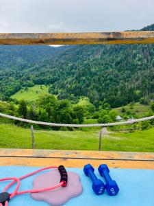 a pair of glasses and flip flops on a table at Mitarbi Silence - cozy holiday cottages in mountains in Borjomi