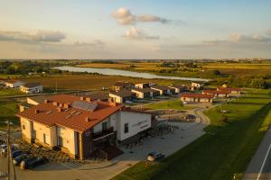 an aerial view of a town with a river and buildings at Motel Panorama in Šiauliai