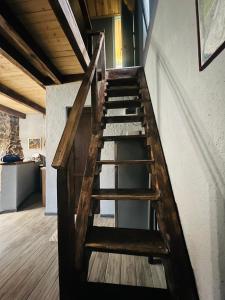 a wooden staircase leading up to a loft at Mitarbi Silence - cozy holiday cottages in mountains in Borjomi