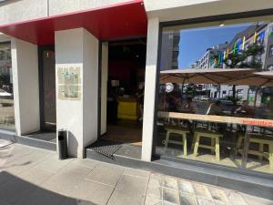 a restaurant with tables and umbrellas on a street at Do Gdyni in Gdynia