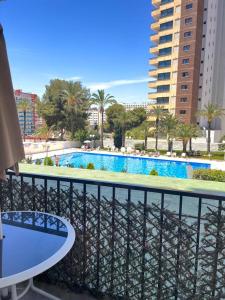 a balcony with a view of a swimming pool at apartament bermudas in Benidorm