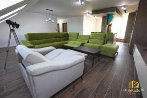 a living room with a couch and a table and a camera at DeLux Center Apartments Inđija in Inđija