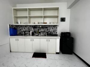 a kitchen with white cabinets and a sink at Casa Emerita in Santa Rosa