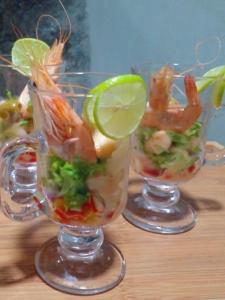 a glass cup filled with shrimp and vegetables on a table at Oruwa Boutique Villas in Arugam Bay