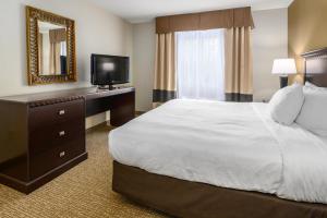 a hotel room with a bed and a television at Hotel 44 North Freeport Brunswick in Freeport
