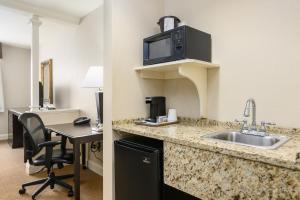 a hotel room with a sink and a desk at Hotel 44 North Freeport Brunswick in Freeport