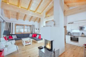 a living room with a couch and a fireplace at Grünerstein Chalet Jungbrunnen in Bramberg am Wildkogel