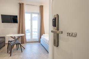 a room with a door to a room with a table at Baia Flegrea Meublè in Bacoli