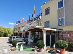 a hotel with a car parked in front of it at Hostal Fronton in Alcobendas