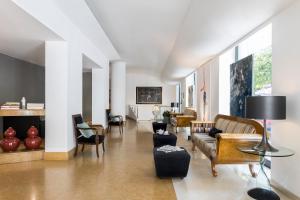 a living room with a couch and chairs at Hotel Plaza Opéra in Palermo