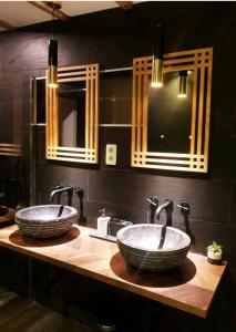 two sinks in a bathroom with two mirrors at Beautiful Duplex in the center of Brussels in Brussels