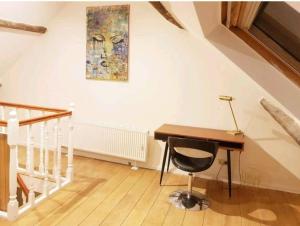 a home office with a desk and a painting on the wall at Beautiful Duplex in the center of Brussels in Brussels