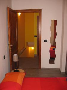 a bedroom with a bed and a hallway with a door at Torrente Rosandra in San Dorligo della Valle