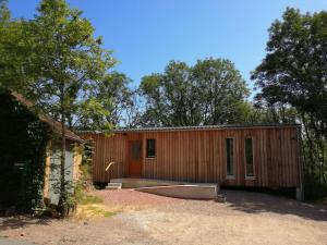 a small wooden house with trees in front of it at Le Nid d'Écureuil in Épiry