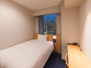 Rúm í herbergi á Sotetsu Fresa Inn Sendai