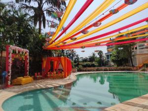 a swimming pool with a party set up with a tent at The Lagoona Resort in Lonavala