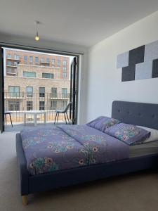 a bedroom with a bed and a large window at The Perfect inn in London