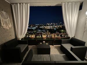 a living room with a view of a city at night at Apartment Paun in Belgrade