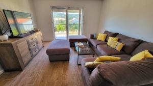a living room with a couch and a tv at Villa Accordo in Vinišće