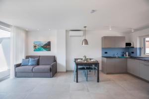 a living room with a couch and a table at Apartments Curti - Himmelblau in Laives