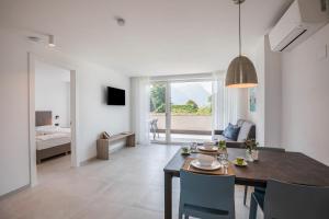 a dining room and living room with a table and chairs at Apartments Curti - Himmelblau in Laives