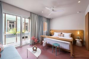sypialnia z dużym łóżkiem i kanapą w obiekcie Alkima Athens Hotel w Atenach