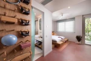 a room with a rock wall and a bedroom at Alkima Athens Hotel in Athens