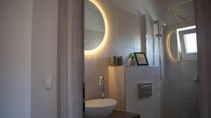 a bathroom with a sink and a mirror at Villa Accordo in Vinišće +23 photos