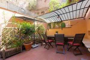 a patio with a table and chairs and plants at Ciambella Art Home-Rental in Rome in Rome