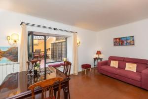 a living room with a red couch and a table at Ciambella Art Home-Rental in Rome in Rome