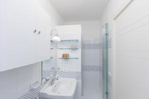 a white bathroom with a sink and a shower at Ciambella Art Home-Rental in Rome in Rome +34 photos