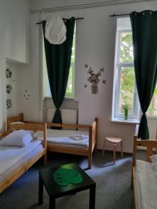 a bedroom with two beds and a window at Green Cat Rooms in Krakow