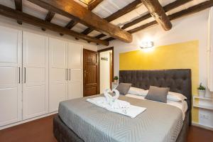 a bedroom with a bed with a white towel on it at Ciambella Art Home-Rental in Rome in Rome