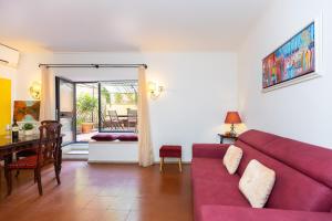 a living room with a red couch and a table at Ciambella Art Home-Rental in Rome in Rome