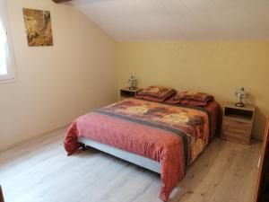 a bedroom with a bed and two night stands at A LA JOIE DE VIVRE Chez l'habitant in Banat
