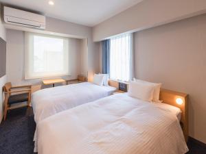 Rúm í herbergi á Sotetsu Fresa Inn Sendai