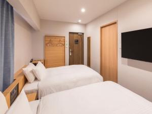 Rúm í herbergi á Sotetsu Fresa Inn Sendai
