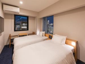 Rúm í herbergi á Sotetsu Fresa Inn Sendai
