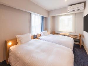 Rúm í herbergi á Sotetsu Fresa Inn Sendai