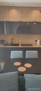 a kitchen with a table and chairs and a counter at Apartament Św. Ducha 29-31 in Gdańsk