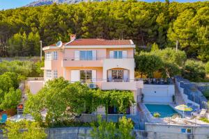 a villa with a swimming pool and a house at Villa Desideria in Solin