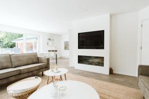 a living room with a couch and a fireplace at West Nieuwlandseweg 25A - Ouddorp - with Pool - NOT FOR COMPANIES in Ouddorp