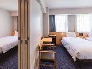 Rúm í herbergi á Sotetsu Fresa Inn Sendai